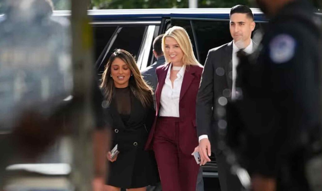 Pam Bondi shows up to meet Epstein survivors while sporting an open shirt displaying a cancer bandage